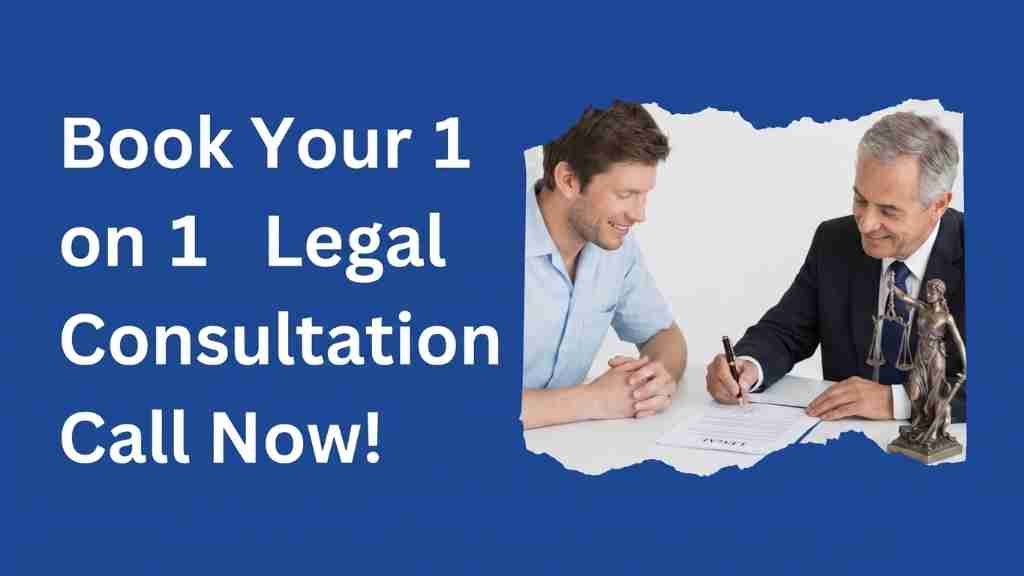An advertisement banner on a solid royal blue background. The left side features bold, white text that reads, "Book Your 1 on 1 Legal Consultation Call Now!". The right side contains a rectangular photograph within a jagged, torn-paper-style frame. In the photo, a younger man in a light blue shirt is sitting across a desk from an older, professional lawyer wearing a suit and tie. Both are looking down at a legal document on the desk, which the lawyer is holding a pen to. A small, bronze Lady Justice figurine with scales stands on the far right of the desk.